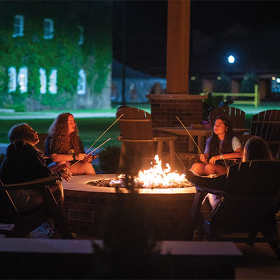 Photo of students around a fire. Link to Gifts by Will.